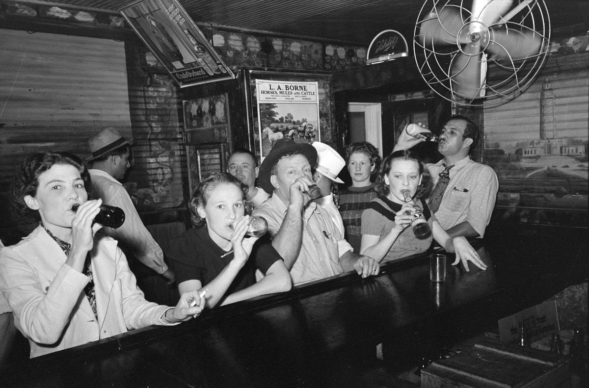 Women and men drinking in a bar in Louisiana, 1938