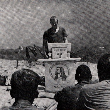 A soldier gives his testimony at a pulpit made by the men of B battery, 6/33 Artillery