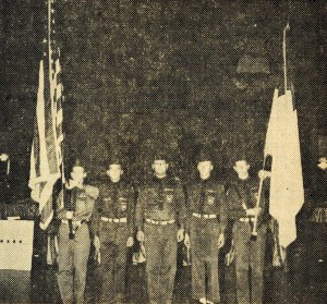 Brigade members at attention. The flag at right appears to be the Christian flag, designed in 1907 by Charles Overton (February 3, 1964 Standard) - Bethel University Digital Library